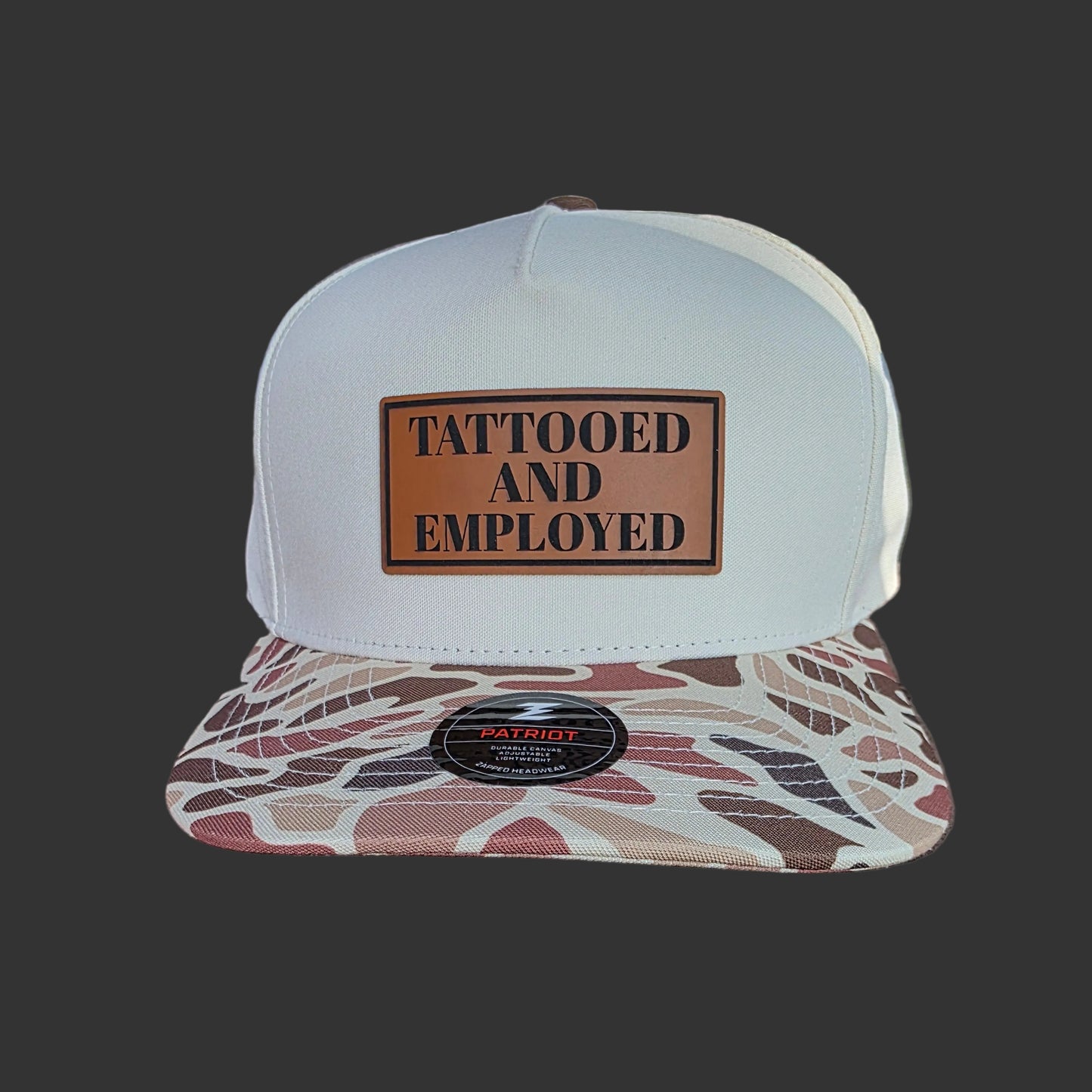 Tattooed and Employed Brown duck camo bill snap back hat.
