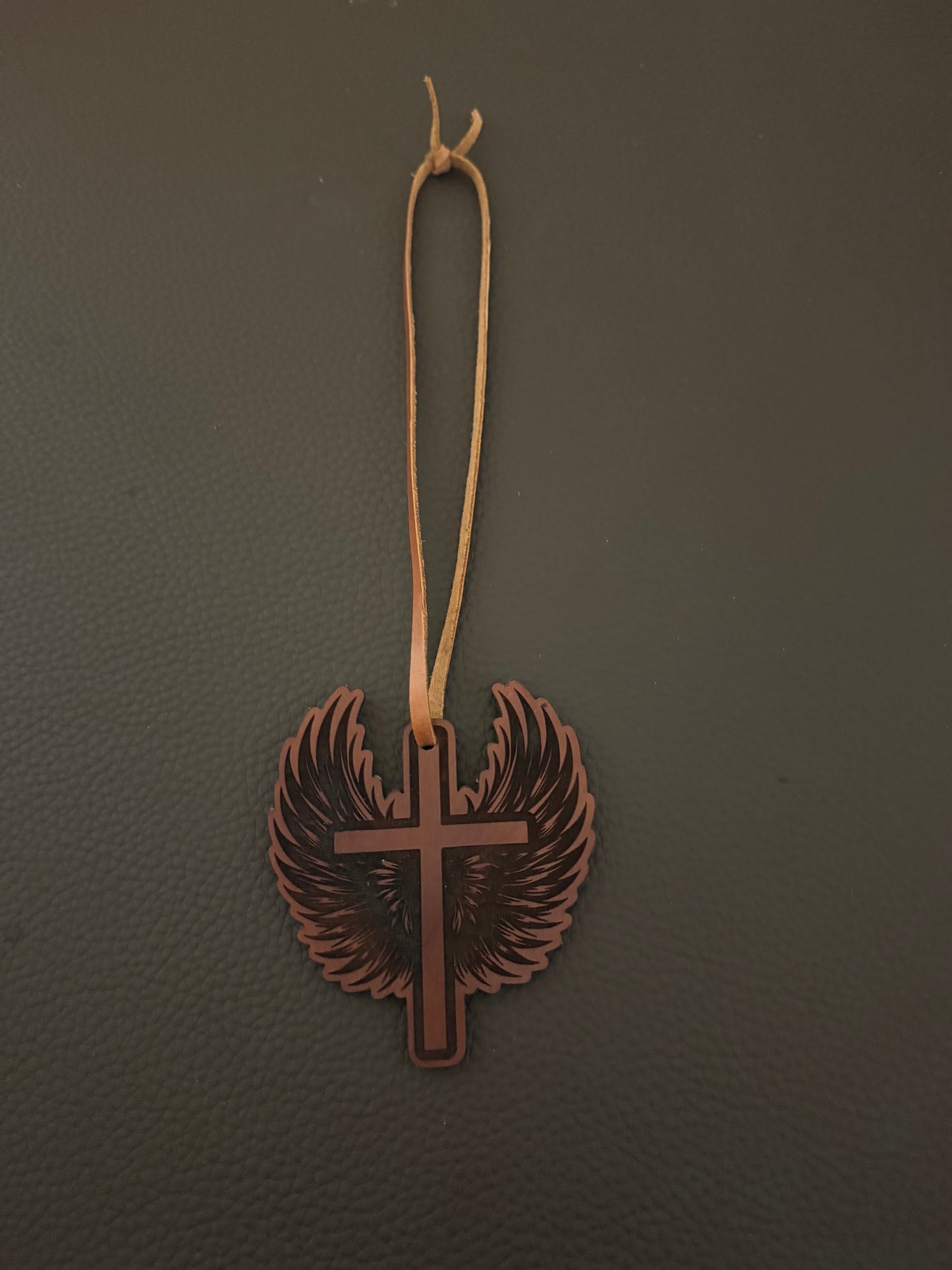 Genuine leather laser engraved car ornament.