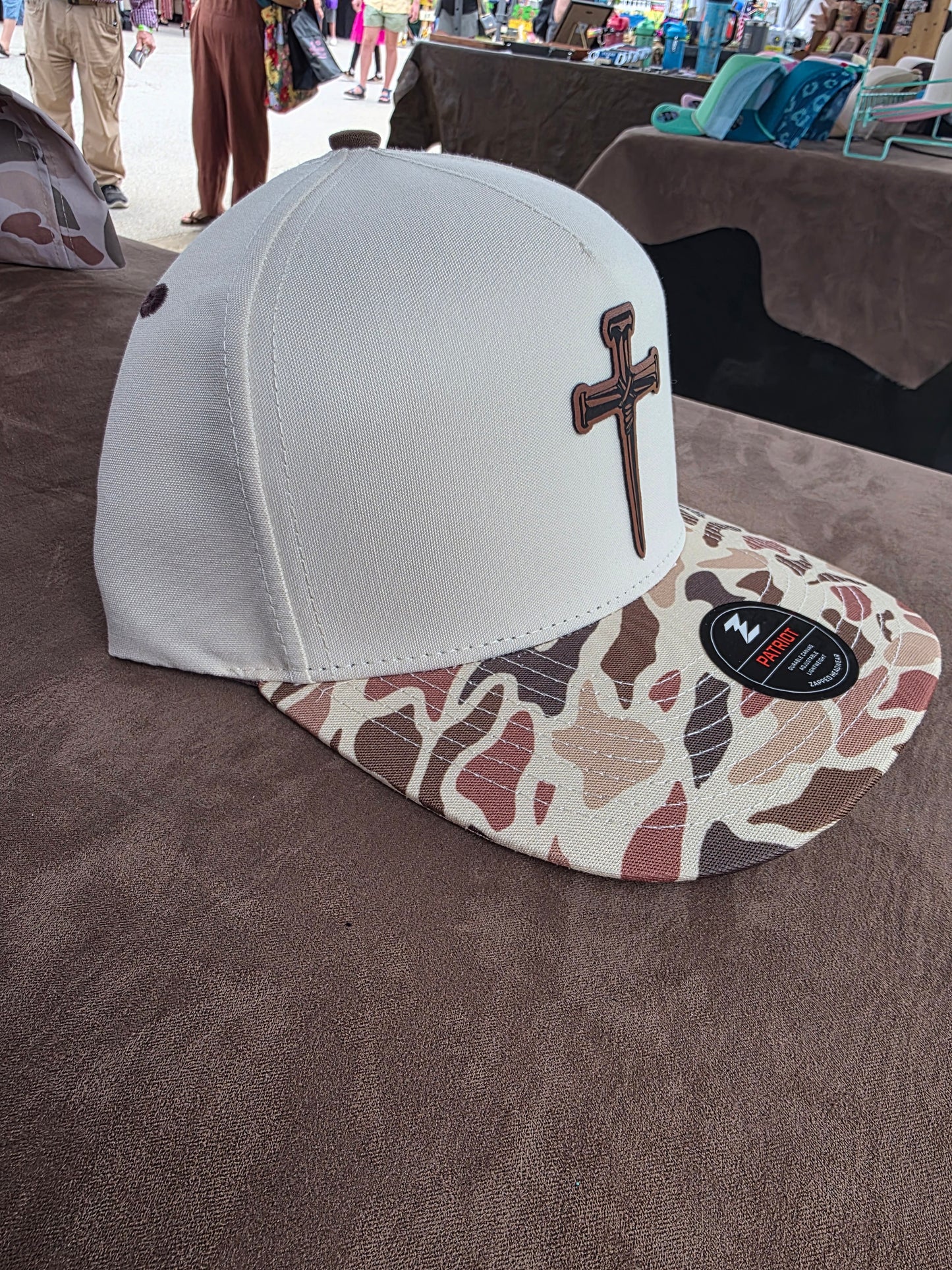 Nail cross patched Camo bill snap back hat. Water repellent!