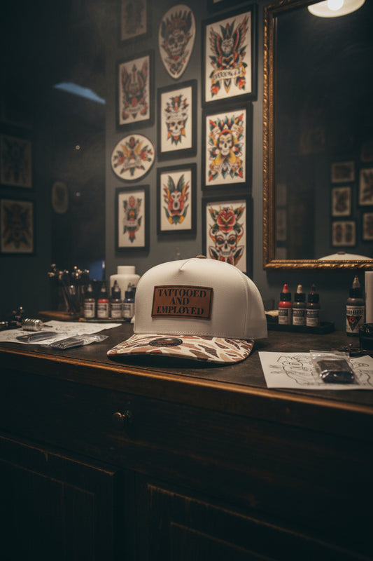 Tattooed and Employed Brown duck camo bill snap back hat.