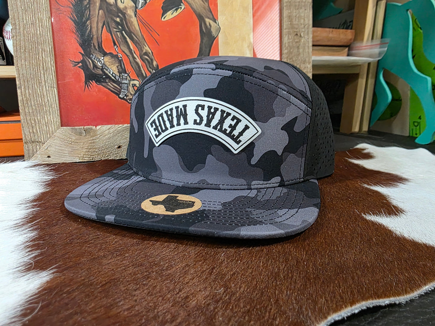 Upside down TEXAS MADE black camo 7 panel snap back hat.