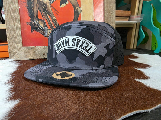 Upside down TEXAS MADE black camo 7 panel snap back hat.