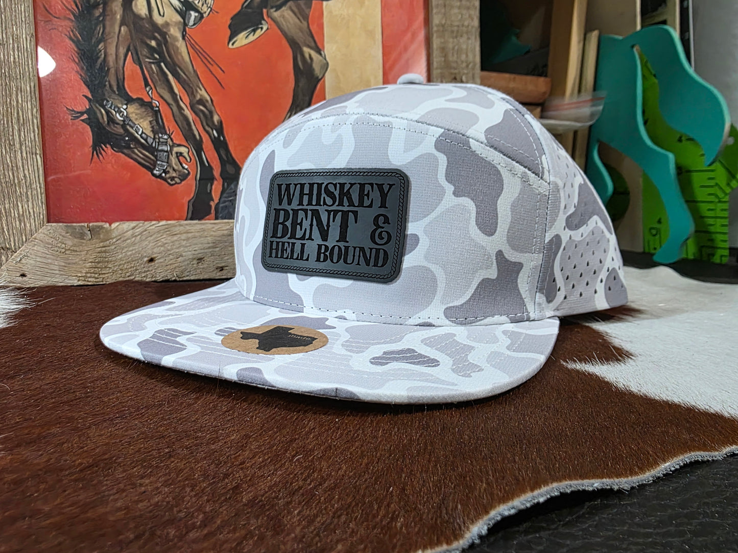 Whiskey bent patched 7 panel snap back hat in snow camo.