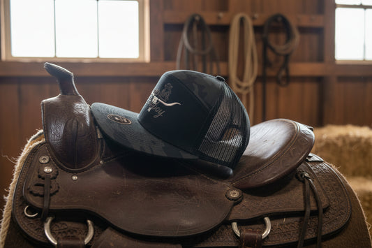 Cowboy embroidered design on a 7 panel flat bill cap.