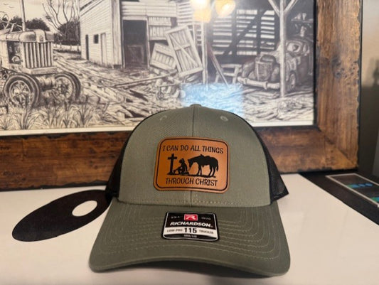 Cowgirl kneeling at cross buckskin leather patched Richardson snap back cap.