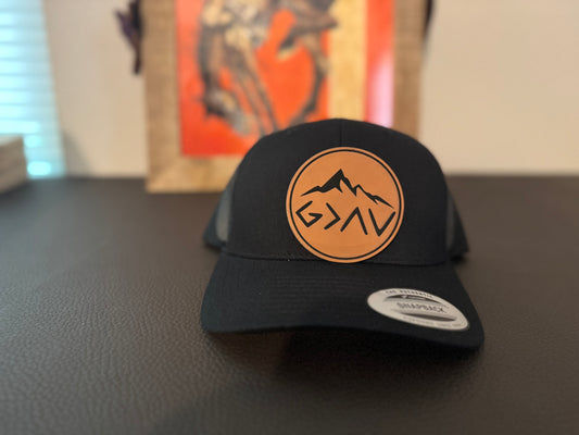 Gods greater than the highs and the lows circle patch in buckskin, with hat.