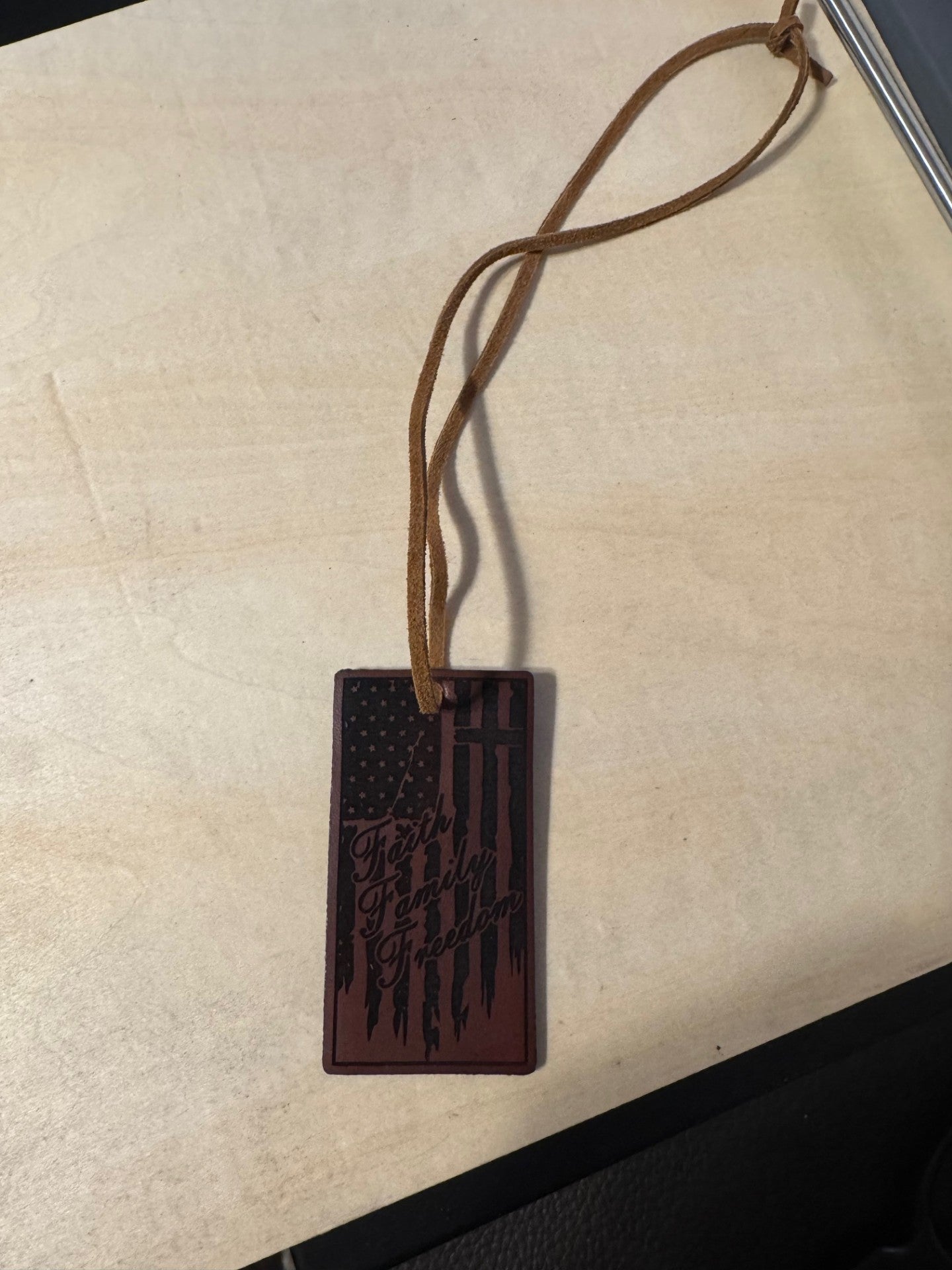 Brown leather Faith, Family, Freedom ornament/rearview mirror charm.