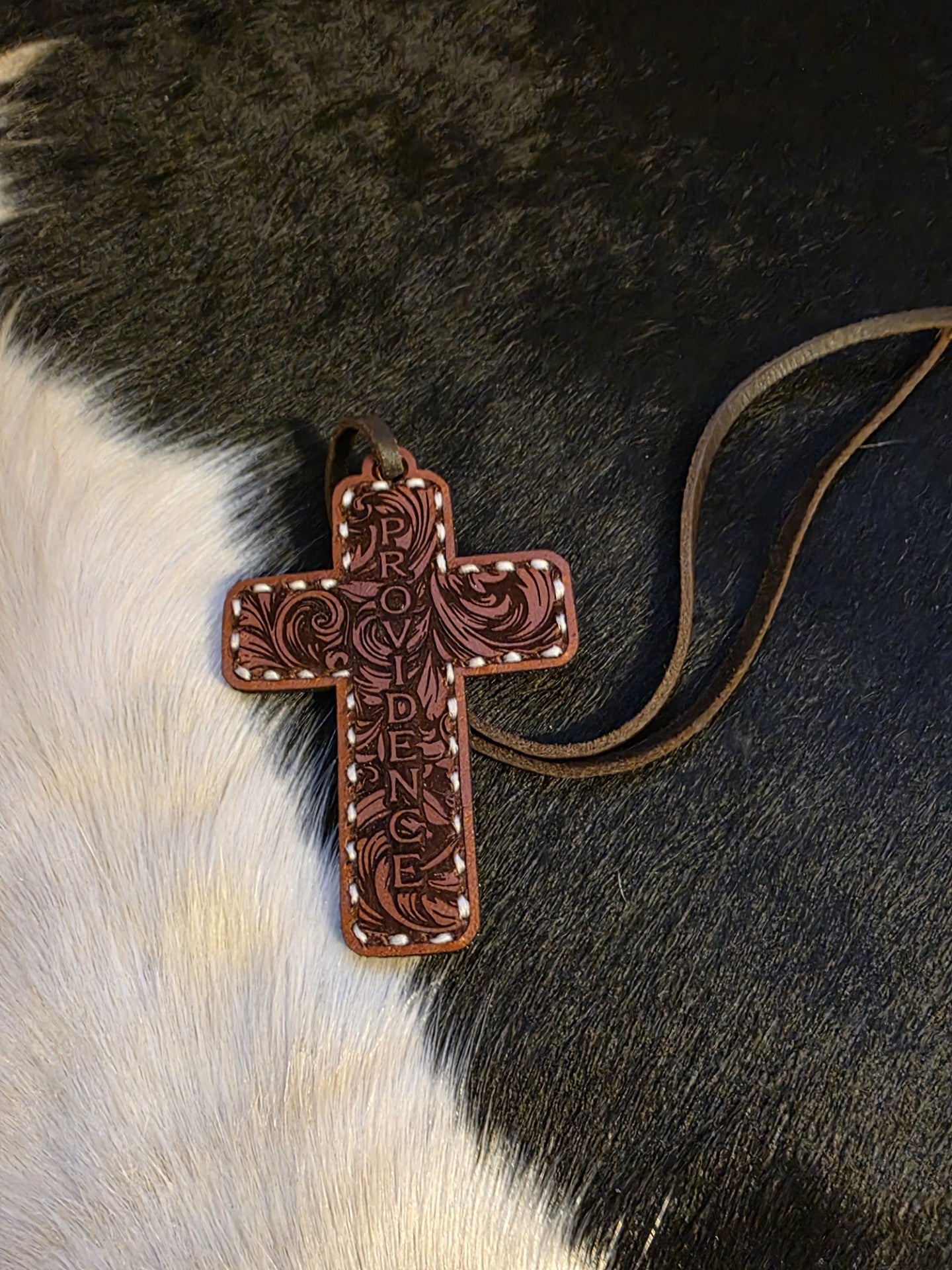 Hand stitched leather rearview mirror cross. Providence design.
